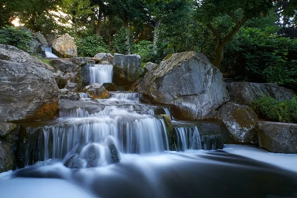 Tranquil Waterfall in Bosnia's Scenic Landscapes. Serene waterfall surrounded by rocks and lush greenery in Bosnia.